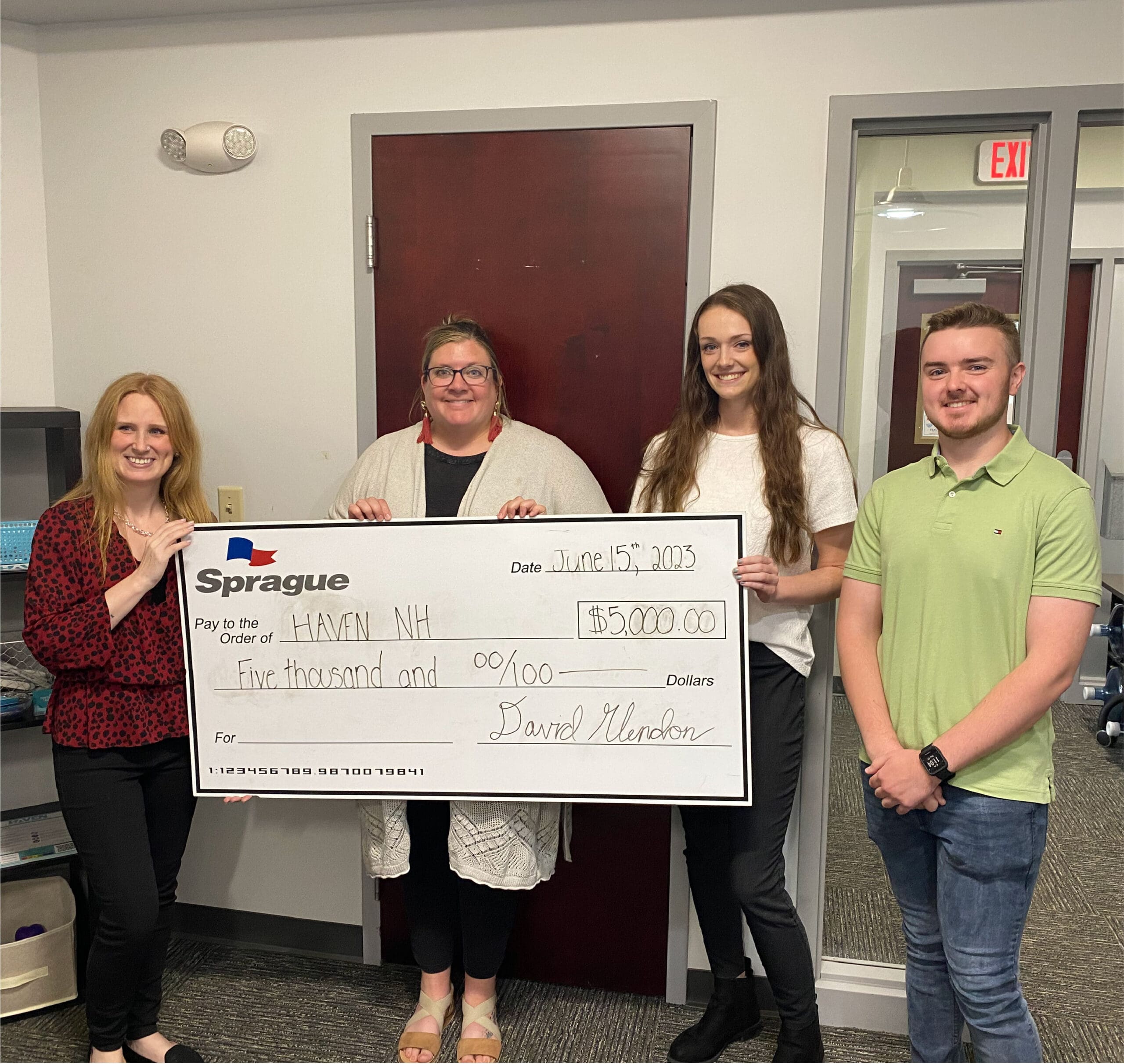 Sprague team presents $5,000 donation to HAVEN NH to support local community services.