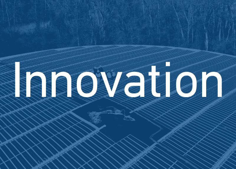 Background picture of solar panels on the top of a tank. The word "Innovation" is layered on top as the main focus.